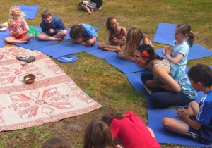 Children saying namaste in kids yoga class.